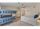 Inviting bedroom with a bunk bed, closet, ceiling fan, and large windows, offering a functional and comfortable space at 4655 Payne St, North Port, FL 34287