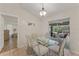 Cozy dining room with glass top table, neutral paint, tile floors, and sliding glass doors at 4655 Payne St, North Port, FL 34287