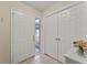 Bright entryway featuring neutral tile, coat closet, and glass sidelight for lots of natural light at 4655 Payne St, North Port, FL 34287