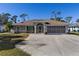 Well-maintained home featuring a two-car garage, beautiful landscaping, and a long driveway at 4655 Payne St, North Port, FL 34287