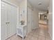 Hallway with tile flooring, coat closet and views to the kitchen at 4655 Payne St, North Port, FL 34287