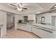 Spacious kitchen featuring white cabinets, tile backsplash, granite countertops, and stainless steel appliances at 4655 Payne St, North Port, FL 34287
