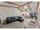 Bright living room featuring vaulted ceilings, wooden beams, tile flooring, and an open layout at 4655 Payne St, North Port, FL 34287