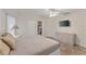 Bright main bedroom boasts a ceiling fan, dresser, and sliding glass doors that lead to the pool at 4655 Payne St, North Port, FL 34287