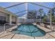 Gorgeous backyard featuring a covered pool with cool decking, perfect for relaxing at 4655 Payne St, North Port, FL 34287