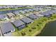 Aerial view showcasing homes within a community featuring a pool and well-maintained lawns at 4711 Cedron Ct, Sarasota, FL 34240