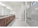 Bathroom featuring double sinks, a large vanity, and a modern glass shower at 4711 Cedron Ct, Sarasota, FL 34240