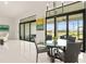 Bright dining area features a modern chandelier and sliding glass doors to the outdoor area at 4711 Cedron Ct, Sarasota, FL 34240