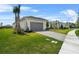Paver driveway leading to a two-car garage, complemented by lush landscaping and green lawn at 4711 Cedron Ct, Sarasota, FL 34240