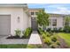 Inviting front entry with a stone walkway, lush landscaping, and modern lighting fixtures at 4711 Cedron Ct, Sarasota, FL 34240