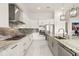 Modern kitchen with white cabinetry, stainless steel appliances, and a large island with marble countertop at 4711 Cedron Ct, Sarasota, FL 34240