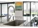 Kitchen island featuring a stainless steel sink, marble countertop, and stylish faucet at 4711 Cedron Ct, Sarasota, FL 34240