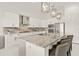 Bright kitchen showcasing a spacious island with elegant pendant lighting and stainless steel appliances at 4711 Cedron Ct, Sarasota, FL 34240