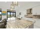 Modern kitchen with marble countertops, white cabinets, and stainless steel appliances at 4711 Cedron Ct, Sarasota, FL 34240