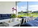 Cozy screened lanai with comfortable seating and serene views of a pond at 4711 Cedron Ct, Sarasota, FL 34240