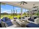 Screened lanai with plush seating offering scenic views of the backyard and pond at 4711 Cedron Ct, Sarasota, FL 34240