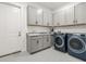Modern laundry room with gray cabinets, granite countertop and new washer and dryer at 4711 Cedron Ct, Sarasota, FL 34240