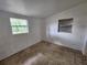 Cozy bedroom with bright white walls and two windows, awaiting personal touches and decor at 4712 Cronin Dr, Sarasota, FL 34232