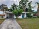 Cozy single-story home with a well-maintained lawn and mature trees providing shade at 4712 Cronin Dr, Sarasota, FL 34232