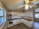 Efficient kitchen with white cabinetry, modern appliances, and a window with natural light at 4712 Cronin Dr, Sarasota, FL 34232