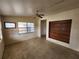 Bright living room featuring large windows, a ceiling fan, and a unique built-in wooden shelf at 4712 Cronin Dr, Sarasota, FL 34232