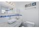 Bathroom with a sleek vessel sink, blue mosaic tile accent, and decorative seashell art at 4801 Sarasota Ave, Sarasota, FL 34234