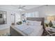 Cozy bedroom featuring a comfortable queen-size bed, modern ceiling fan, and ensuite bathroom at 4801 Sarasota Ave, Sarasota, FL 34234