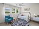 Charming bedroom featuring a playful house-frame bed, natural light, and a blue armchair at 4801 Sarasota Ave, Sarasota, FL 34234