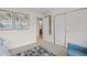 Bright bedroom with a geometric rug, closet space, and views into a bathroom area at 4801 Sarasota Ave, Sarasota, FL 34234