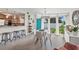 Bright dining space featuring a breakfast bar, a turquoise front door, and views of the front yard at 4801 Sarasota Ave, Sarasota, FL 34234