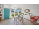 Bright dining area with modern light fixture, and a large window overlooking the well-manicured front yard at 4801 Sarasota Ave, Sarasota, FL 34234