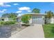 Lovely exterior view showing the garage with eye-catching blue diamond accents and lush landscaping at 4801 Sarasota Ave, Sarasota, FL 34234