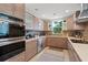 Well-equipped kitchen features modern appliances, wooden cabinets, and a stylish backsplash at 4801 Sarasota Ave, Sarasota, FL 34234