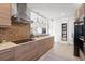 Modern kitchen featuring sleek wooden cabinetry, stainless steel appliances, and a stylish tile backsplash at 4801 Sarasota Ave, Sarasota, FL 34234