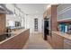 Spacious kitchen with stainless steel appliances, wooden cabinets, and a view into the adjoining living space at 4801 Sarasota Ave, Sarasota, FL 34234