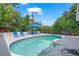 Enjoy the refreshing backyard pool and lounge area surrounded by lush landscaping and privacy at 4801 Sarasota Ave, Sarasota, FL 34234