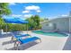 Relax by the sparkling pool with lounge chairs and a shade umbrella on this home's property at 4801 Sarasota Ave, Sarasota, FL 34234