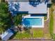 Aerial shot of a backyard featuring a pool, lush greenery, and a charming shed at 4806 Capri Ave, Sarasota, FL 34235