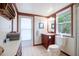 Well-lit bathroom featuring cherrywood vanity, white tile, and window bringing in natural light at 4806 Capri Ave, Sarasota, FL 34235