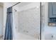 Updated bathroom with shower over tub, subway tile, and gray vanity at 4806 Capri Ave, Sarasota, FL 34235
