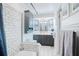 Modern bathroom featuring subway tile in shower, elegant vanity, and window bringing in natural light at 4806 Capri Ave, Sarasota, FL 34235