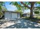 Charming home exterior with a spacious driveway, lush landscaping, and inviting curb appeal at 4806 Capri Ave, Sarasota, FL 34235