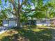 Charming single-story home with a well-manicured lawn and mature tree offering plenty of shade at 4806 Capri Ave, Sarasota, FL 34235