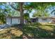 Charming single-story home with a well-manicured lawn and mature tree offering plenty of shade at 4806 Capri Ave, Sarasota, FL 34235