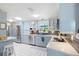 Modern kitchen featuring stainless steel appliances, light blue cabinets, and sleek countertops at 4806 Capri Ave, Sarasota, FL 34235