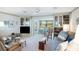 Bright and airy living room with built-in shelving and a seamless flow to the outdoor dining area at 4806 Capri Ave, Sarasota, FL 34235