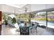 Covered and screened patio with tile floor, ceiling fans, and outdoor furniture offering a great view of the private pool at 4806 Capri Ave, Sarasota, FL 34235
