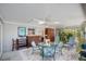 Large enclosed patio with ceiling fans, tile floor, and outdoor furniture overlooking lush and private backyard landscaping at 4806 Capri Ave, Sarasota, FL 34235