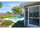 Inviting backyard pool with lush landscaping, shed, and screened in patio at 4806 Capri Ave, Sarasota, FL 34235
