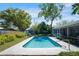 Inviting backyard pool with lush landscaping, and a charming shed offering a serene outdoor retreat at 4806 Capri Ave, Sarasota, FL 34235